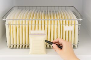 A tidy stack of flat-frozen breast milk storage bags organized in a freezer basket, illustrating the quantity needed for storage.