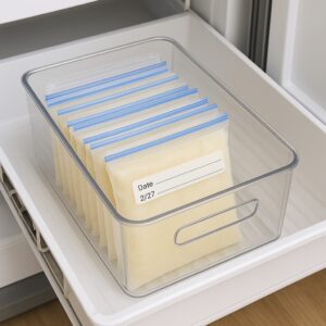 An organized freezer drawer with labeled, flat-frozen breast milk bags, representing a freezer stash built before returning to work.