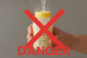 A clear visual warning showing a bottle of frozen breast milk being held under a stream of very hot/boiling water, overlaid with a bold red 'X' symbol.
