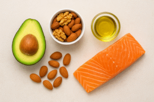 Generate a vibrant, organized top-down (flat-lay) food photograph in a **4:3 landscape aspect ratio**. Arrange various healthy, omega-3 rich foods such as **sliced avocado, walnuts/almonds, a drizzle of olive oil, and perhaps a small piece of salmon**. The arrangement should be aesthetically pleasing and symbolize **dietary enrichment** of milk quality.