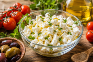Fresh white crumbled feta cheese garnished with oregano and olive oil for health benefits